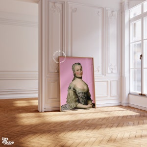 May include: A framed portrait of a woman in a white and black dress with a pink background. The woman is wearing a pearl necklace and has her hair pulled back.