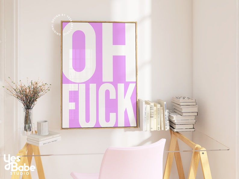 May include: A pink and white framed print with the text "OH FUCK" in white letters on a pink background.