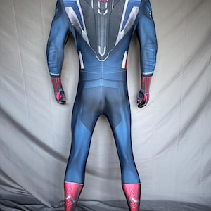May include: A blue and red superhero costume with a detailed design. The suit features a blue base with red accents on the gloves and boots. The back has a silver, white, and red design.