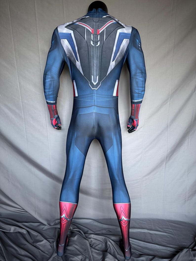 May include: A blue and red superhero costume with a detailed design. The suit features a blue base with red accents on the gloves and boots. The back has a silver, white, and red design.