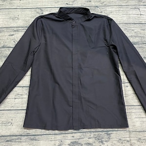 May include: A black long-sleeved shirt with a mandarin collar and a button-up front.