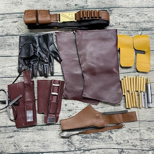 May include: A set of brown leather cosplay accessories, including a belt, gloves, and boot covers. The set also includes a brown leather holster, a brown leather belt with a buckle, and a set of gold-colored darts.