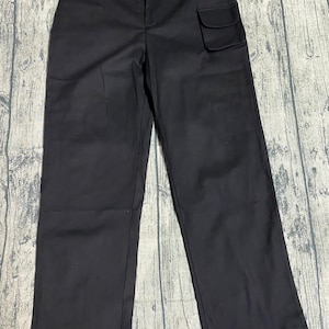 May include: Black cargo pants with a large pocket on the right side.