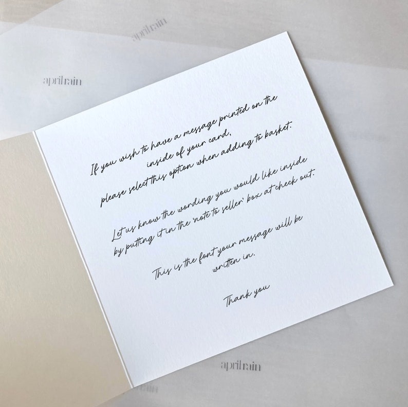 May include: White card with black text explaining how to add a personalized message to a card. The text reads: "If you wish to have a message printed on the inside of your card, please select this option when adding to basket. Let us know the wording you would like inside by putting it in the note to seller box at check out. This is the font your message will be written in. Thank you."
