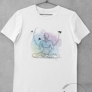 May include: White t-shirt featuring a graphic of a person in a yoga pose, formed from interconnected dots. The design is set against a watercolour-like background in shades of blue, purple, and pink. Three small black birds are depicted flying around the person.