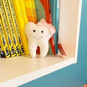 Felt Tooth Fairy with pink bow and a smiling face