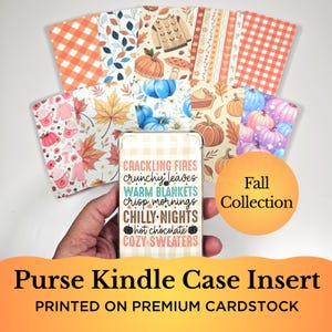 May include: A collection of fall-themed purse Kindle case inserts. The inserts feature various autumn patterns, including pumpkins, leaves, and sweaters. The Kindle case insert in the center has text that reads "Crackling Fires, Crunchy Leaves, Warm Blankets". The words "Fall Collection" are also visible.