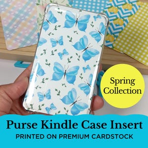 May include: Clear Kindle case insert with a white background and a pattern of light blue butterflies and green leaves. The text "Purse Kindle Case Insert" and "Spring Collection" are visible.