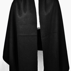 May include: A black pashmina scarf with fringe on the ends.