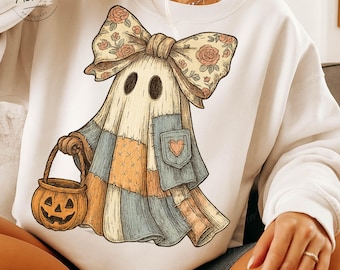 May include: White sweatshirt featuring a whimsical ghost design. The ghost wears a patchwork outfit with a heart pocket and a floral bow. It carries a jack-o'-lantern bucket, perfect for Halloween. The design has a vintage, hand-drawn aesthetic.