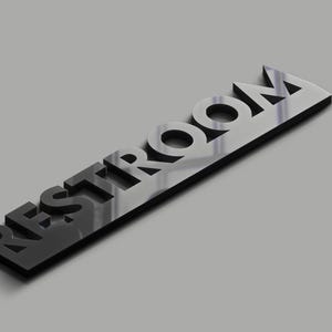 May include: Black and white 3D sign that reads "RESTROOM" with a reflective surface.