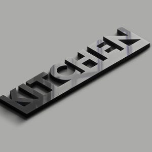 May include: A black, three-dimensional sign that spells out the word "KITCHEN" in a sans-serif font. The sign is angled slightly, with a gray background. The letters are cut out, creating a shadow effect.