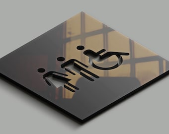 May include: A black and white sign with a cut-out design of a family and a wheelchair symbol. The sign is made of a reflective material and has a blurred background.