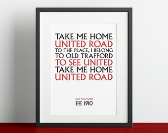 May include: Black and white print with red text that reads "Take me home United Road, to the place, I belong to Old Trafford, to see United, Take me home United Road". The text is centered on a white background with the words "Old Trafford Est 1910" at the bottom.