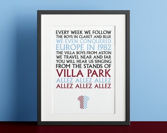 May include: A framed print with a blue and white striped soccer jersey design. The text reads "Every week we follow the boys in claret and blue. We even conquered Europe in 1982. The Villa boys from Aston. We travel near and far. You will hear us singing from the stands of Villa Park. Allez Allez Allez. Allez Allez Allez."