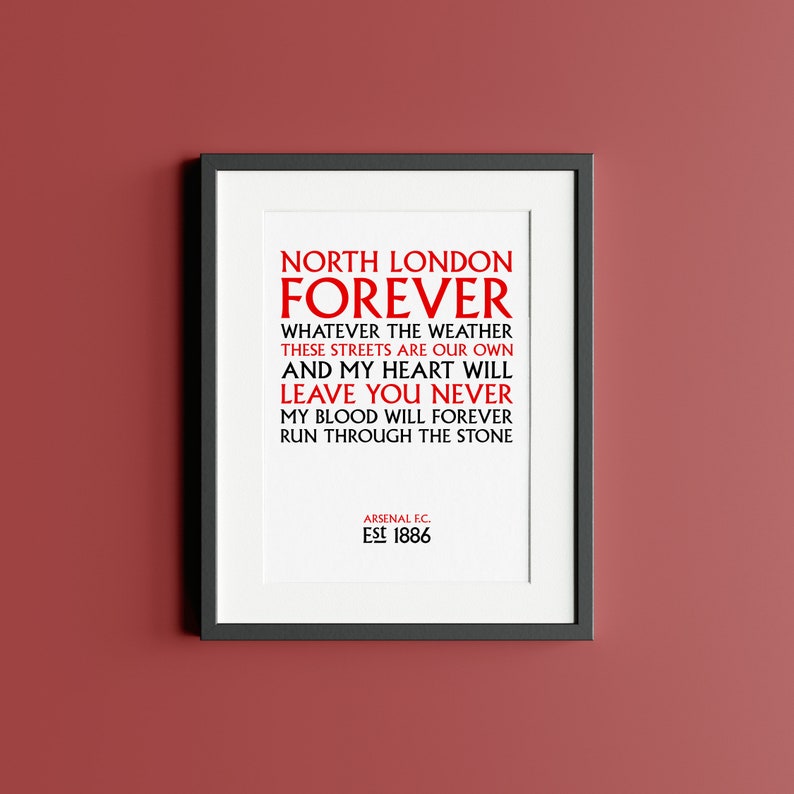 May include: A white framed print with black text that reads "North London Forever" and "Whatever the weather these streets are our own and my heart will leave you never my blood will forever run through the stone." The text is in red. The bottom of the print reads "Arsenal F.C. Est 1886".