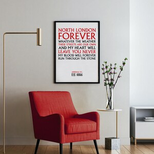 May include: A black framed print with white background and red text that reads "North London Forever" with the words "Whatever the weather these streets are our own and my heart will leave you never my blood will forever run through the stone" and "Arsenal FC. Est 1886".
