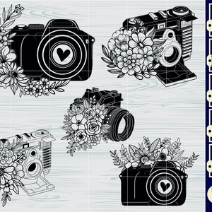May include: Black and white digital download of four camera designs with floral embellishments. Each design features a camera with a heart in the lens and floral accents. The designs are labeled with file types: SVG, PNG, DXF, EPS, and PDF.
