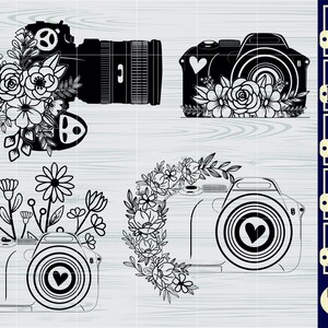 May include: Four black and white camera designs with floral embellishments. Each camera has a heart shape in the lens. The designs are suitable for crafting projects such as vinyl decals, iron-on transfers, and digital downloads.