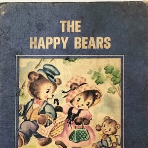 May include: Vintage children's book titled "The Happy Bears" with a blue cover. The cover features an illustration of three bears in a forest setting. The book is part of the "Tiny Elf Library" series. A quarter is next to the book for size comparison.