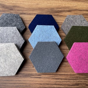 May include: Nine hexagonal felt sound absorbing panels in various colors, including gray, light gray, dark gray, blue, light blue, green, and pink.