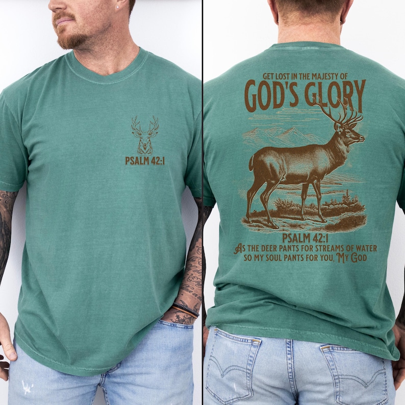 A green t-shirt with a brown deer silhouette and the text 'PSALM 42:1' on the front. The back has a larger brown deer silhouette with the text 'GET LOST IN THE MAJESTY OF GOD'S GLORY'. Mens Christian Shirts, Bible Verse Shirt, Hunting Gifts, Husband Gift, Deer Hunter, Father's Day Gift, Jesus Shirt, Adult Baptism Gifts, Men's Shirt, Religious Shirt, Christian Gift, Religious Gift For Men, Hunting T-shirt, Deer Tshirt, Comfort Colors Tshirt