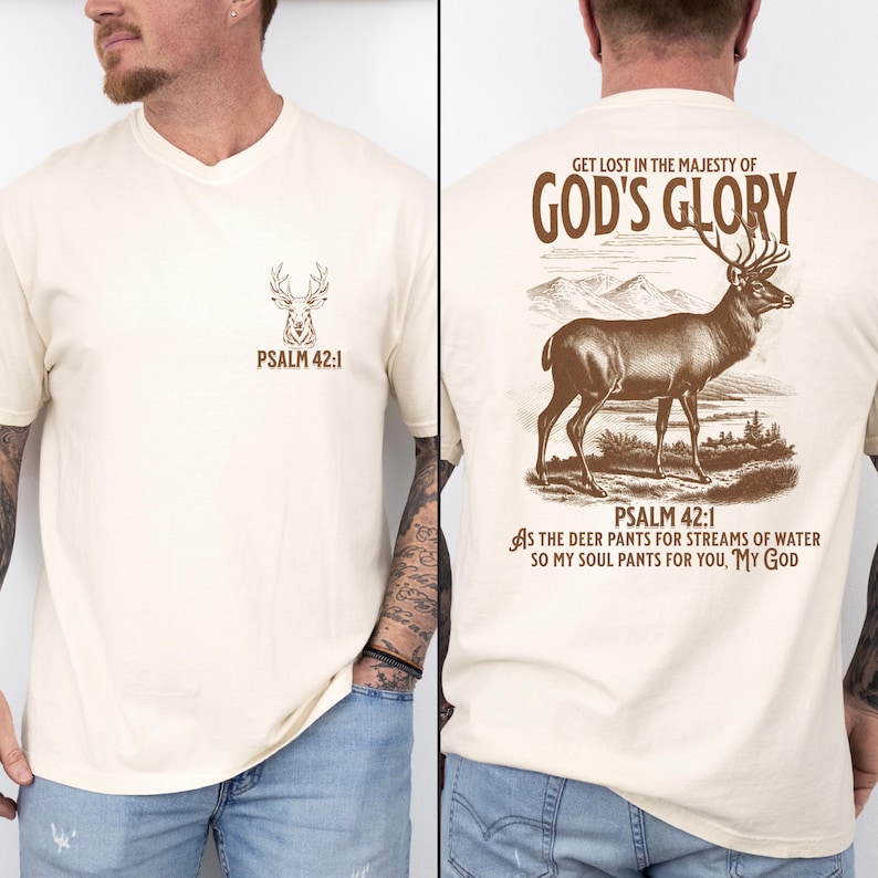 A cream t-shirt with a deer illustration and the text 'PSALM 42:1' on the front. The back has a brown deer illustration and the text 'GET LOST IN THE MAJESTY OF GOD'S GLORY'. Mens Christian Shirts, Bible Verse Shirt, Hunting Gifts, Husband Gift, Deer Hunter, Father's Day Gift, Jesus Shirt, Adult Baptism Gifts, Men's Shirt, Religious Shirt, Christian Gift, Religious Gift For Men, Hunting T-shirt, Deer Tshirt, Comfort Colors Tshirt