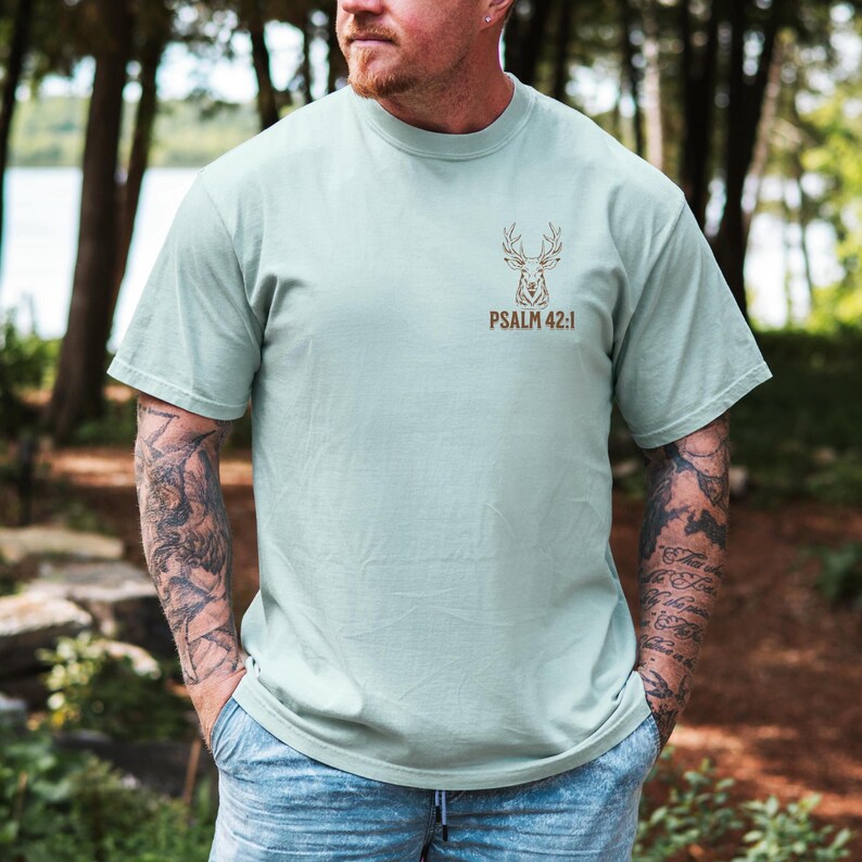 May include: A light sage green t-shirt with a brown deer silhouette and the text 'PSALM 42:1'. Mens Christian Shirts, Bible Verse Shirt, Hunting Gifts, Husband Gift, Deer Hunter, Father's Day Gift, Jesus Shirt, Adult Baptism Gifts, Men's Shirt, Religious Shirt, Christian Gift, Religious Gift For Men, Hunting T-shirt, Deer Tshirt, Comfort Colors Tshirt