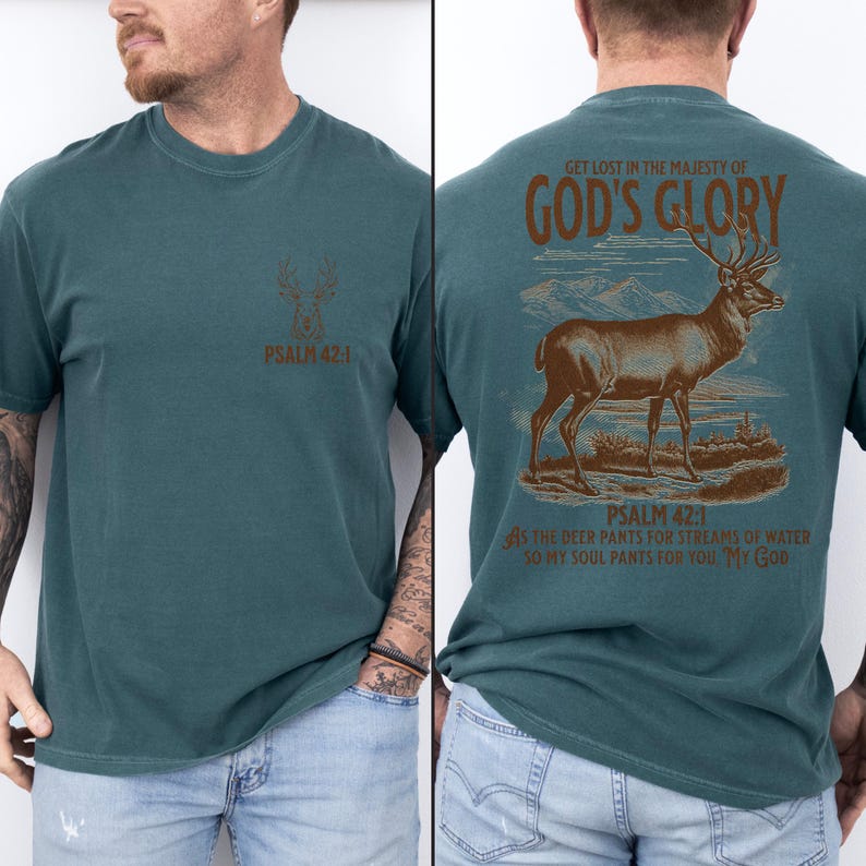 A teal t-shirt with a brown deer illustration and the text 'GET LOST IN THE MAJESTY OF GOD'S GLORY' on the back. The front of the shirt has a smaller deer illustration and 'PSALM 42:1'. Mens Christian Shirts, Bible Verse Shirt, Hunting Gifts, Husband Gift, Deer Hunter, Father's Day Gift, Jesus Shirt, Adult Baptism Gifts, Men's Shirt, Religious Shirt, Christian Gift, Religious Gift For Men, Hunting T-shirt, Deer Tshirt, Comfort Colors Tshirt