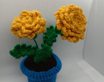 crochet marigold flowers in blue plant pot