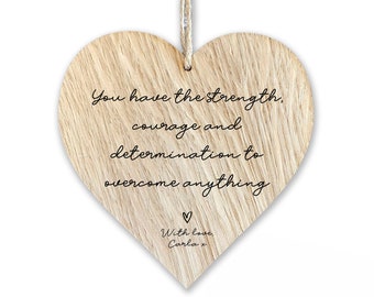 May include: Wooden heart-shaped sign with the text "You have the strength, courage and determination to overcome anything" and "With love, Carla x".