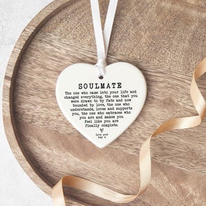 a heart-shaped ornament with a message about love and relationships.