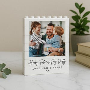 May include: White Lego-style photo block with a photo of a father and two children. The text "Happy Father's Day Daddy Love Max & Annie XX" is printed on the bottom of the block.