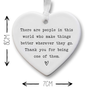 The image is a heart-shaped ornament with a message about making a positive impact on others.
