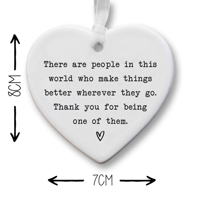 The image is a heart-shaped ornament with a message about making a positive impact on others.