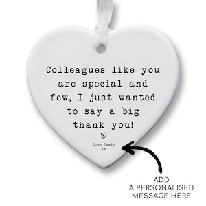 The image is a heart-shaped ornament with a personalized message inside it. The message reads, "Colleagues like you are special and few, I just wanted to say a big thank you!" The ornament also includes a black arrow pointing to the message, indicating where it was added.