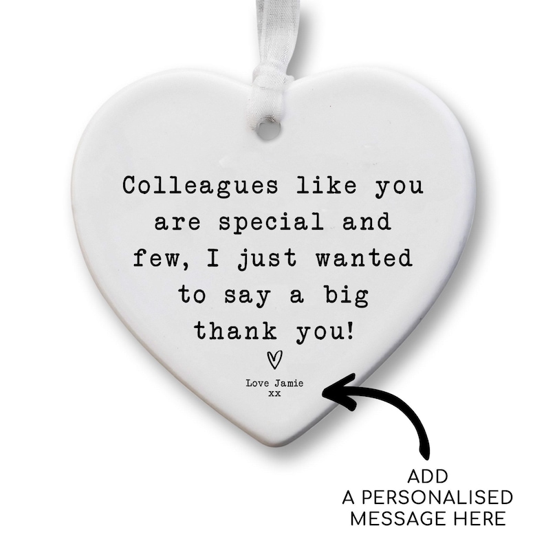 The image is a heart-shaped ornament with a personalized message inside it. The message reads, "Colleagues like you are special and few, I just wanted to say a big thank you!" The ornament also includes a black arrow pointing to the message, indicating where it was added.