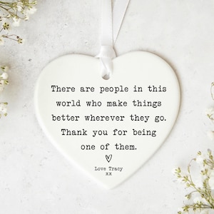 a heart-shaped ornament with a message written on it.