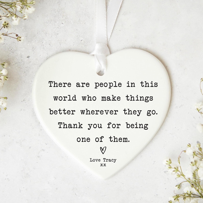 a heart-shaped ornament with a message written on it.