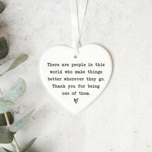a heart-shaped ornament with a message about appreciating people who make things better, along with a heart symbol.