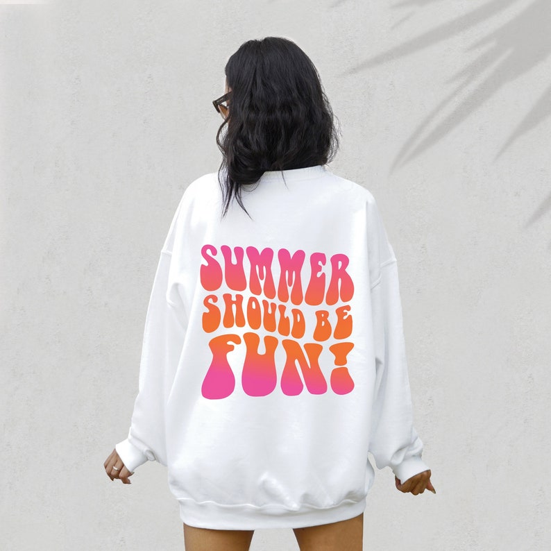 May include: White sweatshirt with a pink and orange graphic print on the back that says "Summer should be fun!"