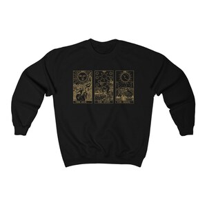 K&ouml;nnte beinhalten: Schwarzes Sweatshirt mit goldenen Tarotkarten-Designs. Das Design umfasst die Karten Sonne, Stern und Mond. Der Text "THE SUN", "THE STAR" und "THE MOON" ist unter jeder Karte aufgedruckt. Das Sweatshirt ist aus weichem Material.