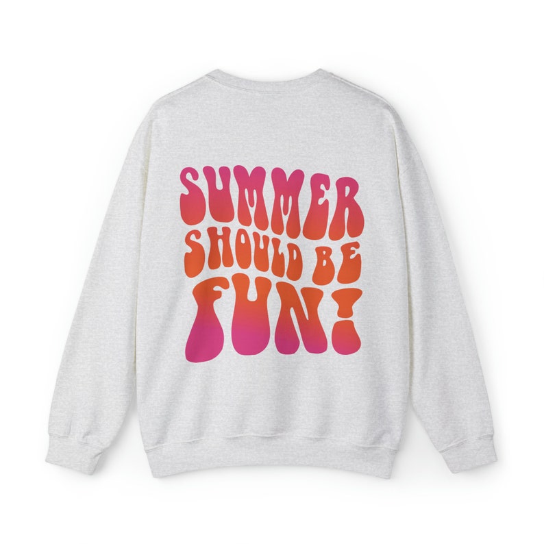 May include: A light grey sweatshirt with a graphic print on the back. The graphic is in a retro style and says "Summer should be fun!" in pink and orange.