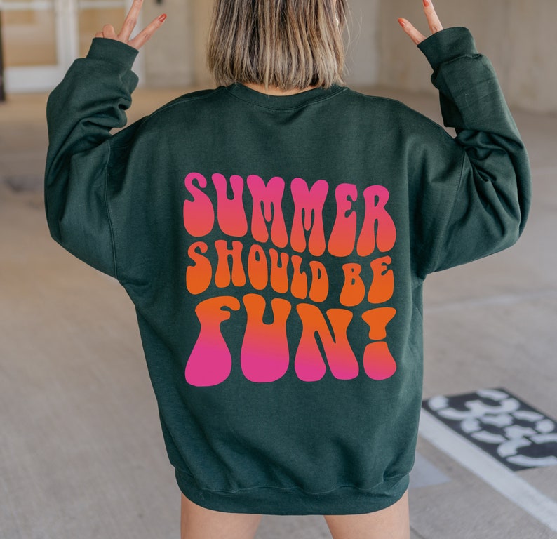 May include: A dark green sweatshirt with the text "Summer should be fun!" printed in pink and orange letters in a retro font.