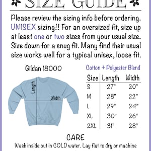 May include: Size chart for a unisex sweatshirt, showing measurements in inches for length and width. The chart includes sizes S, M, L, XL, and 2XL. The sweatshirt is light blue and has a crew neck. The text "Gildan 18000" and "Cotton + Polyester Blend" are also visible.
