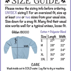 May include: Size chart for a unisex sweatshirt, showing measurements in inches for length and width. The chart includes sizes S, M, L, XL, and 2XL. The sweatshirt is light blue and has a crew neck. The text "Gildan 18000" and "Cotton + Polyester Blend" are also visible.