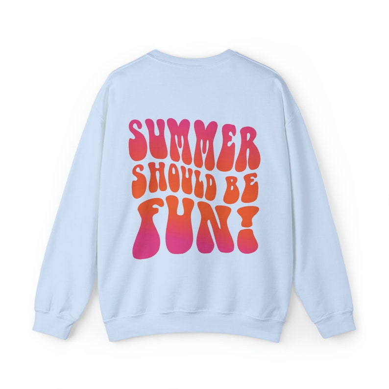 May include: Light blue sweatshirt with a graphic print of the text "SUMMER SHOULD BE FUN!" in a retro, psychedelic font with a gradient of pink and orange.