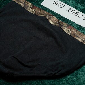 May include: Black headwear with a camouflage pattern along the top edge. The tag in the image reads "SKU 10623". The headwear appears to be made of a soft, flexible material.