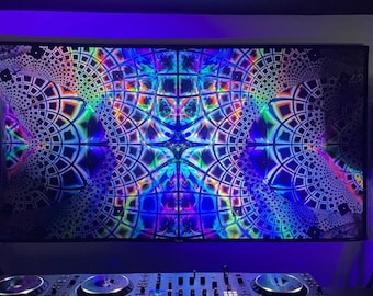 May include: A DJ mixer with two turntables and a control panel in front of a large screen displaying a colorful, psychedelic, geometric pattern.