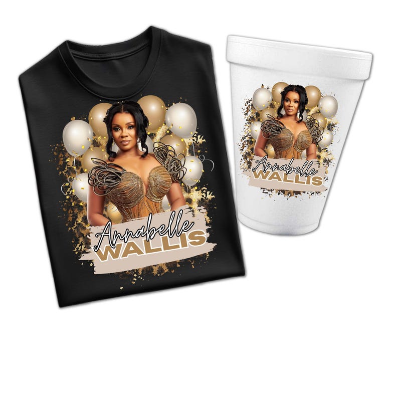 May include: Black t-shirt and white foam cup featuring a design with a woman, balloons, and the text "Annabelle Wallis." The design includes gold and beige accents, creating a celebratory theme. The cup and shirt are displayed together.